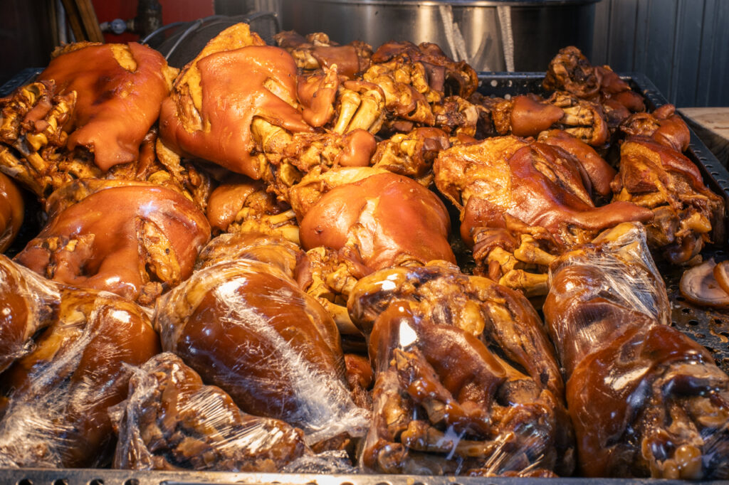 Close-up of braised pig’s feet (jokbal) stacked and ready for sale at a Korean market